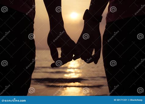 Love Couple Holding Hands Fingers At Sunset On The Beach Stock Image