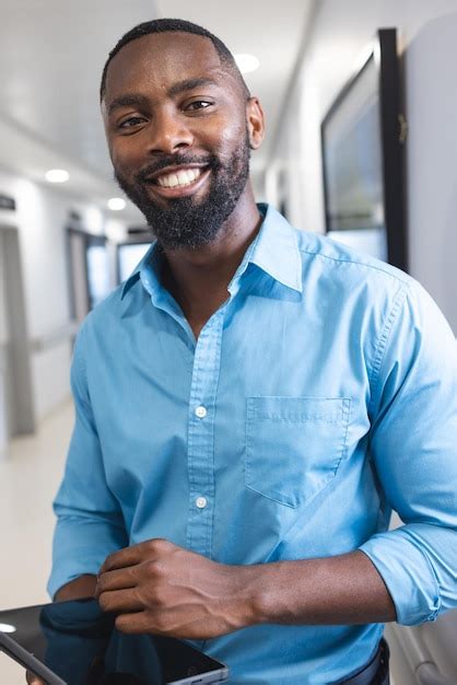 Premium Photo Portrait Of Happy African American Male Doctor Holding