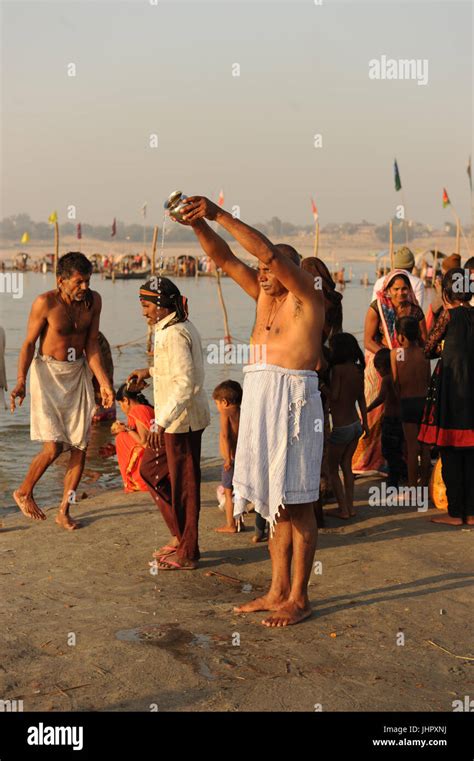 Hindu Devotees Bath At The Banks Of The Ganges At The The Triveni