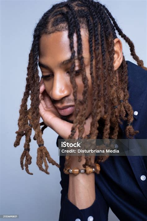 Africanamerican Man In Professional Attre With Locs In Face While