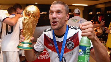 Lukas Podolski Of Germany Holds Up The World Cup Trophy In The Germany