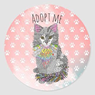 a round sticker with an image of a cat on it's back and the words adopt me