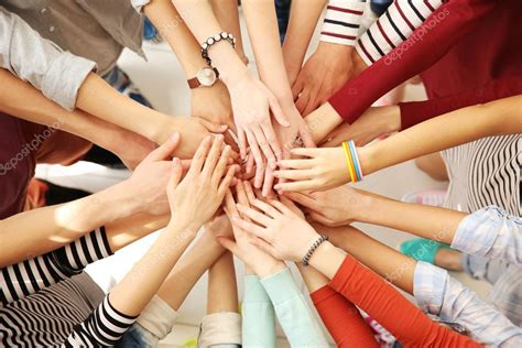 Group of people hands together Stock Photo by ©belchonock 115910310 