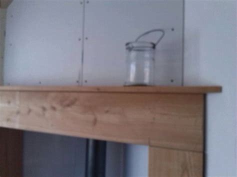 A Glass Jar Sitting On Top Of A Wooden Mantle