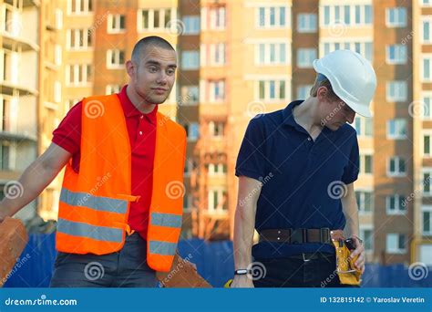 Construction Manager And Engineer Working On Building Site Stock Photo