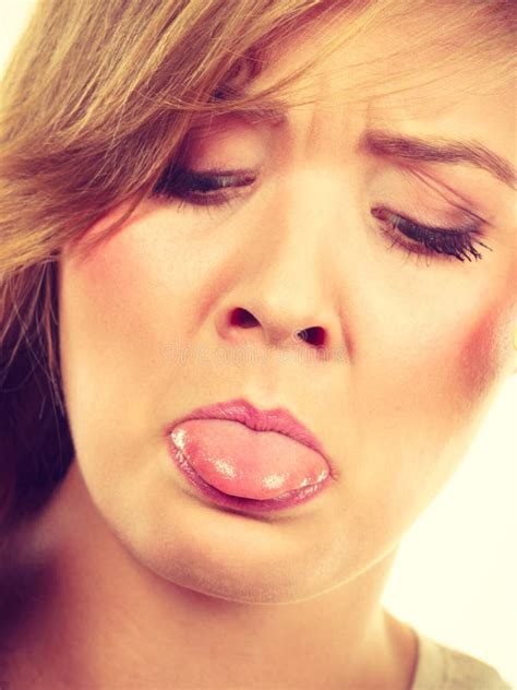closeup portrait  woman sticking tongue  stock photo image