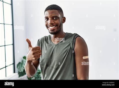 Young African American Man Getting Vaccine Showing Arm With Band Aid