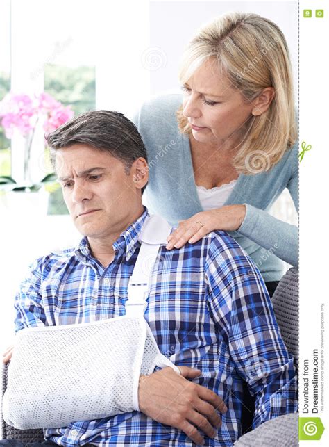 Wife Comforting Husband Suffering With Arm Injury Stock Image Image