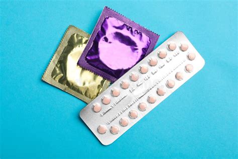 Condoms And Birth Control Pills On Pink Background Safe Sex Stock