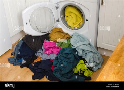 Washing machine, colorful clothes. Pile of laundry Stock Photo - Alamy