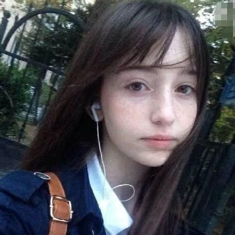 A Girl With Headphones On Taking A Selfie