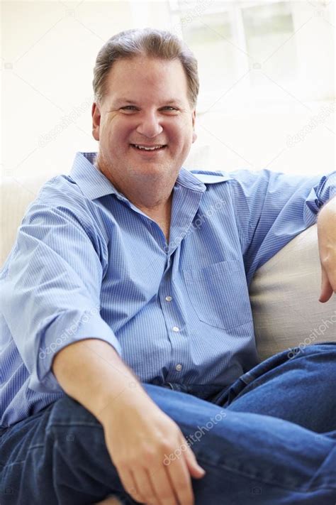 Overweight Man Sitting On Sofa — Stock Photo © Monkeybusiness 59875679