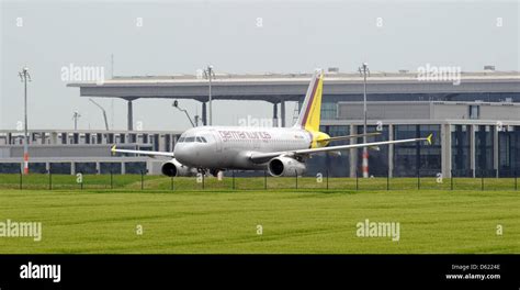 An Airplane Taxis Passed The Buildings Of The New Berlin Brandenburg