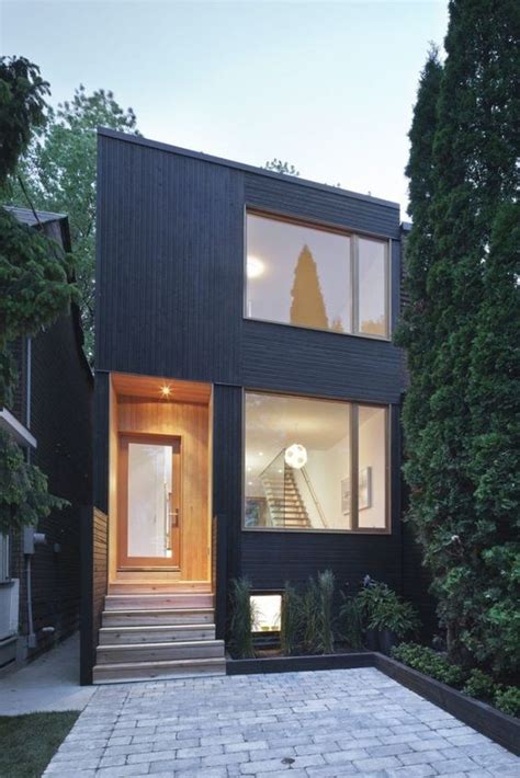 A Black House With Stairs Leading Up To It