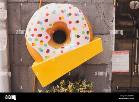 Giant Donut Sign In Front Of Cafe Or Restaurant With Empty Copy Space