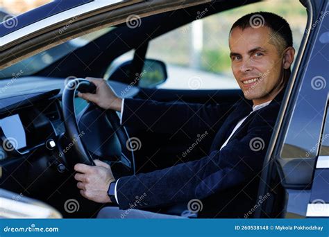 Portrait Of Handsome Businessman Smiling While Driving A New Car Young