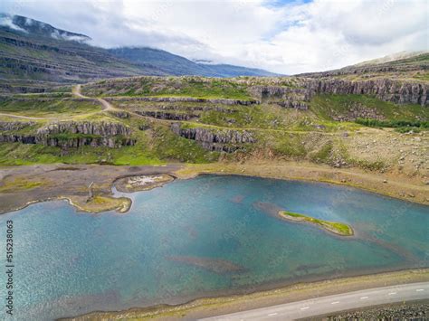 Aerial view of roads and lake at the inner end of fjord Berufjordur ...