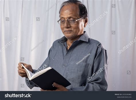 indian man reading books standing stock photo  shutterstock
