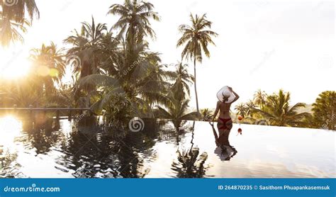 Estilo De Vida Del Tiempo Feliz Con Una Joven En Bikini Rojo Mirando La Puesta De Sol Al Lado De