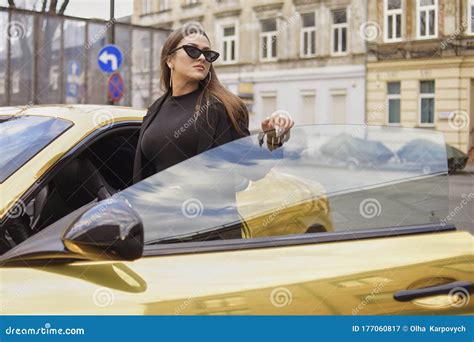Gorgeous Brunette Gets Out Of Her Expensive Golden Car The Girl Is Rich Gorgeous Brunette