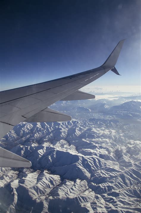 Photo of Airplane Flying over Mountains