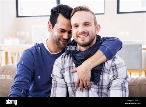 Gay Couple Hugging On The Couch Stock Photo Alamy