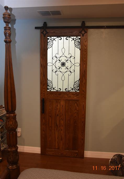 Solid Oak 180 Pound Barn Door With Wrought Iron And Rain Glass Installed Barn Door Rain Glass