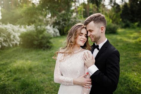 Elegant Gorgeous Bride And Stylish Groom Posing In The Park Stock