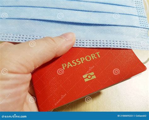 Hand Holding A Passport And A Surgical Face Mask Stock Image Image Of Mask Vaccination 218069533