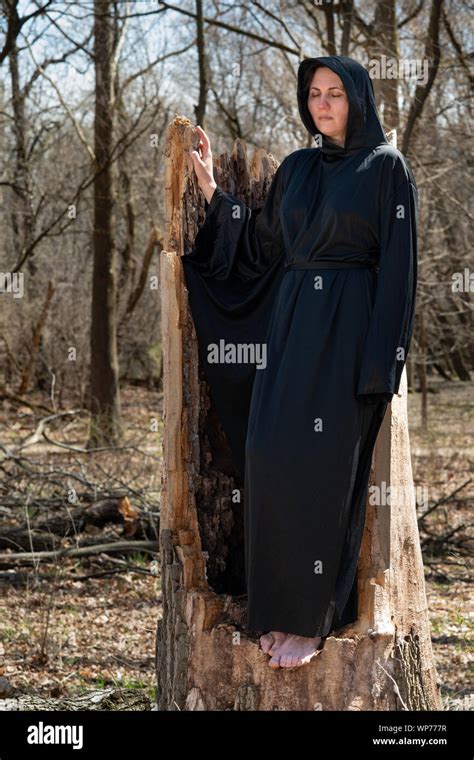 Hooded Woman In Black Robes Deep In The Forest Witches Halloween And