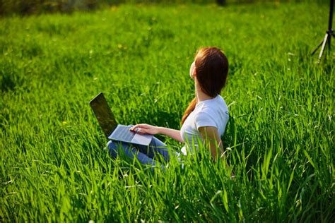 Premium Photo Rear View Of Woman Reading Book While Sitting On Grassy