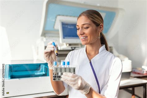 Laboratory Assistant Putting Test Tubes Into The Holder Scientist