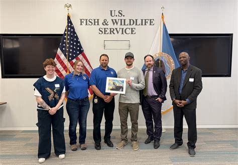 2024 National Junior Duck Stamp Art Contest judges with winning artwork | FWS.gov