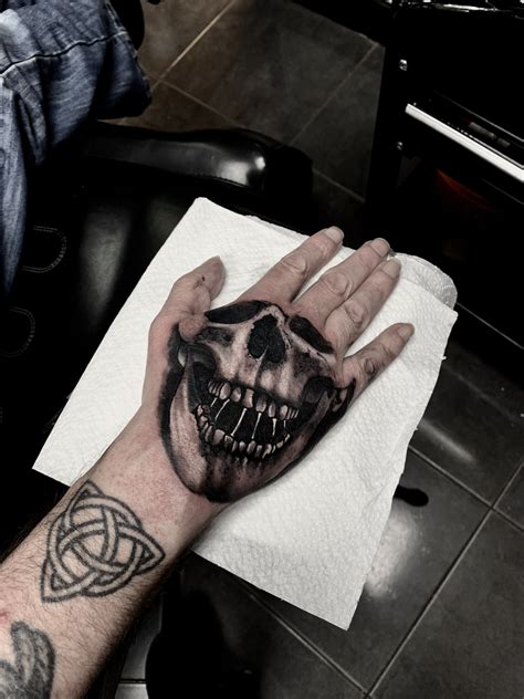 Face Your Fears The Meaning Behind The Skull Hand Tattoo Get Inspired