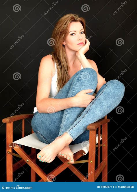 Beautiful Relaxed Thoughtful Young Woman Sitting In A Chair Stock Image