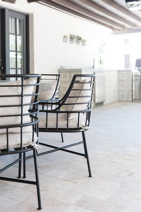 Cb2 Breton Black Metal Chairs On Gray Pavers Transitional Deckpatio