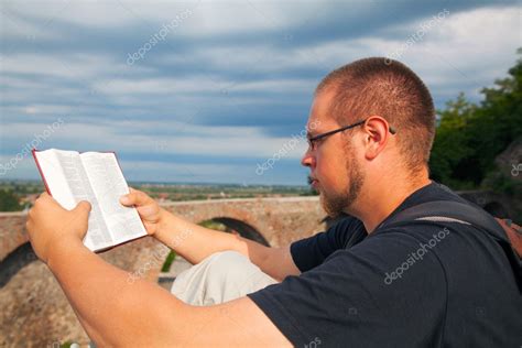 Young Man Reading The Bible — Stock Photo © Andreykr 11961754