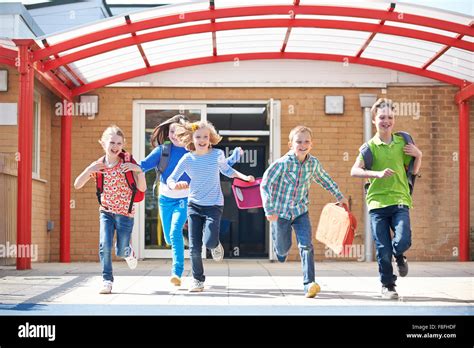 schoolchildren running  playground    class stock photo alamy