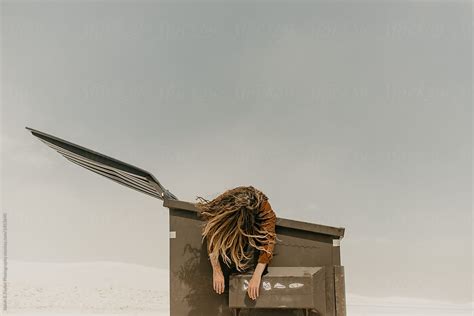 Man Hanging Dead Over A Dirty Trash Bin With His Hair Covering His