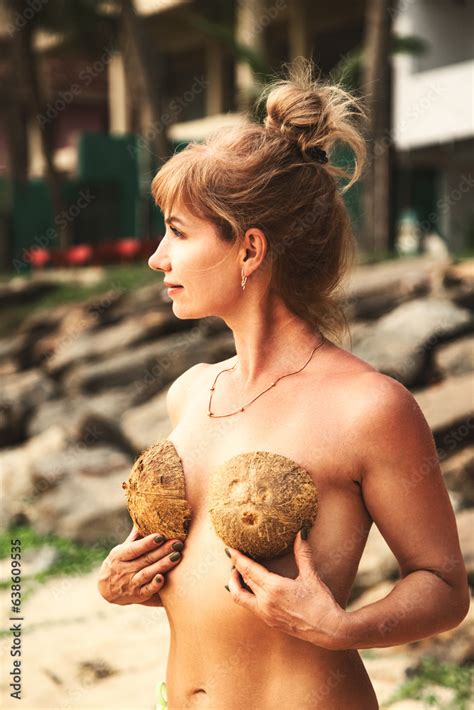 Naturist Naked Woman Covered Her Breasts With Coconuts In Tropic