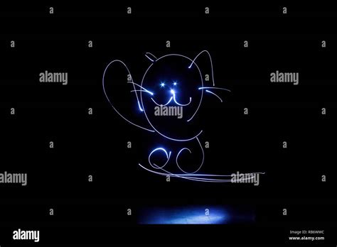 Kids freezelight drawn by light on black background Stock Photo - Alamy