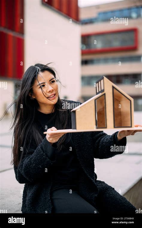 Architect analyzing architectural model house outside office building ...