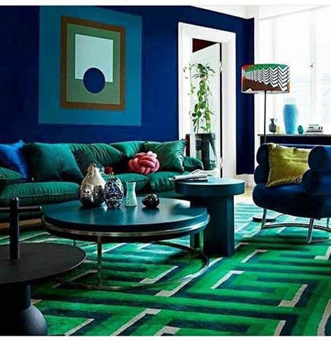 A Living Room With Blue Walls And Green Carpeted Flooring Two Chairs