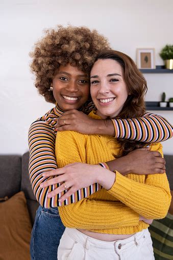 Close Up Of Beautiful And Cheerful Multiracial Lesbian Couple Hugging