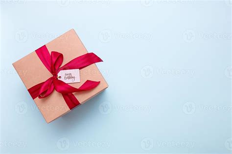 gift box with a satin ribbon and the inscription happy birthday on a ...