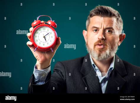 Bearded Businessman In Suit Holding Red Alarm Clock Time Management