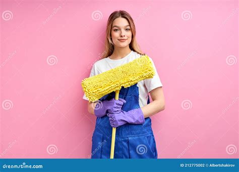 Nice Young Caucasian Maid Going To Clean Floor With Mop Stock Photo