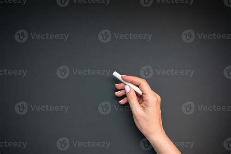 Teacher hand with piece of chalk 13355226 Stock Photo at Vecteezy