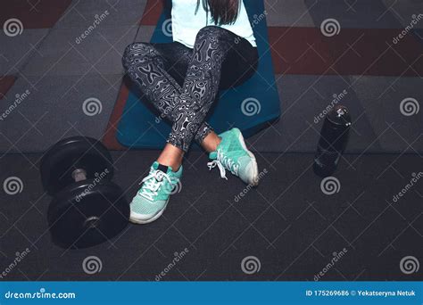 Sport Woman Sitting And Resting After Workout Or Exercise In Fitness