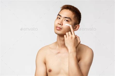 Beauty People And Leisure Concept Sassy Good Looking Asian Man With Naked Torso Taking Care Of